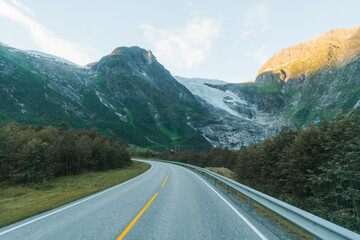 Road through forest in mountains 