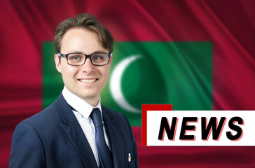News anchor, tells the latest news, smiling, against the background of the flag of Maldives