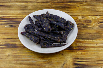 Slices of biltong (South African dried meat) on wooden table