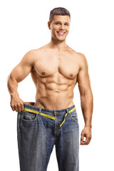 Smiling young man trying on a big pair of jeans