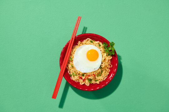 Tasty boiled instant noodles with a sunny side-up egg served