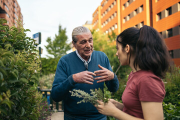Young woman learning cultivation techniques in an urban garden