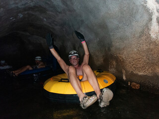 A man in an inner tube a river tunnel