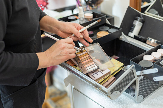 Close Up Of A Makeup Artist Grabbing Cosmetics With Her Brushes
