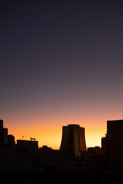 Sunrise during a summer day in Brazil with bright horizon and building