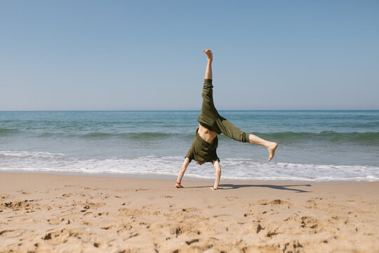 Man spinning on the seashore
