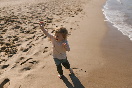 Toddler running by the sea