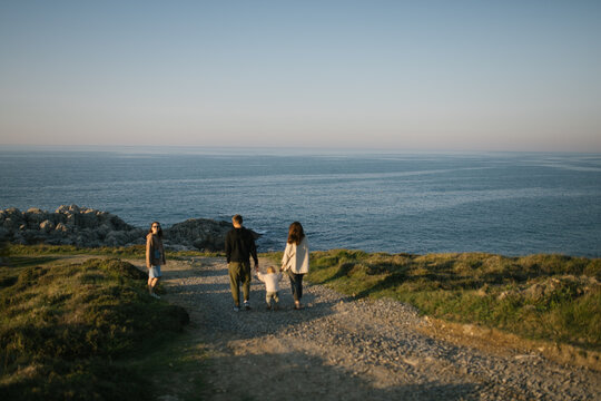 Friends walking by the sea