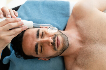 Man in spa receiving facial treatment.