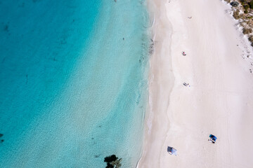 Aerial view of turquoise clear ocean and white sand beach
