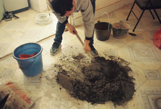 The workers are mixing cement
