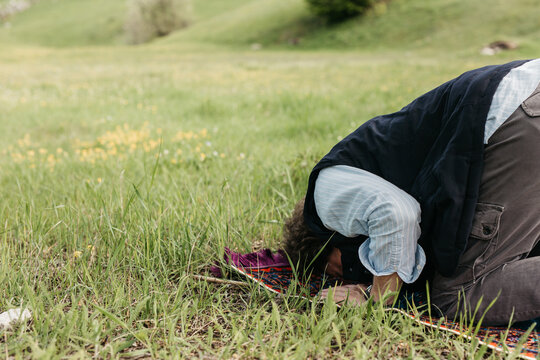 man praying salah in nature