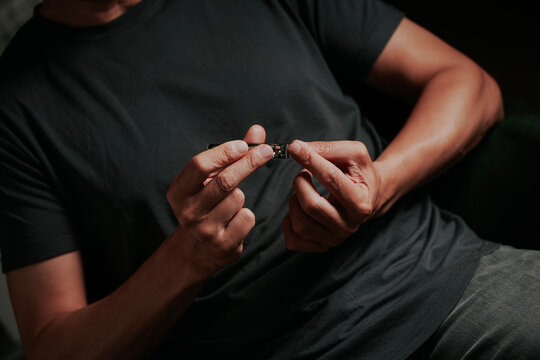 man cuts his fingernails with a nail cutter