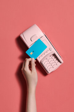 Pay by payment terminal on pink background