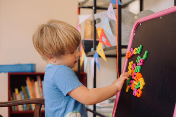Boy playing with letters