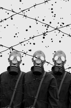 Group of soldiers in gas masks behind barbed wire