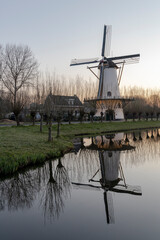 Historic windmill of Zandweg, Rotterdam with a reflection in the water