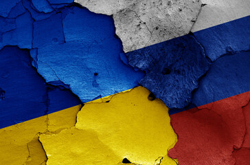 flags of Ukraine and Russia  painted on cracked wall