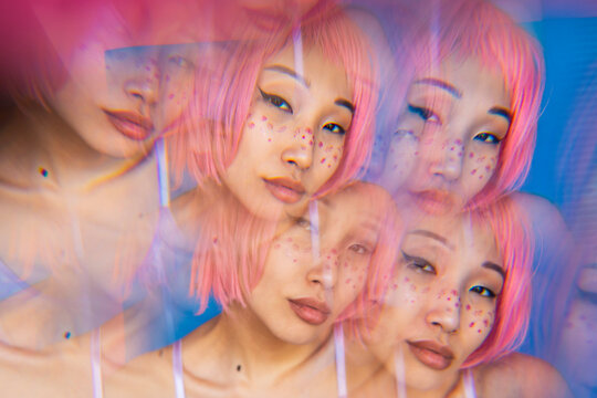 Multiple exposure of young Asian woman with pink hair 
