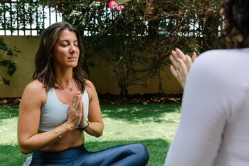 Women meditating in the garden