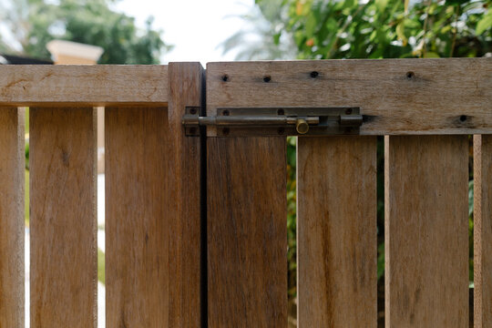 A wooden gate with a lock