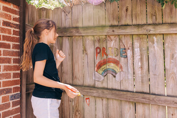 Rainbow chalk drawing on fence