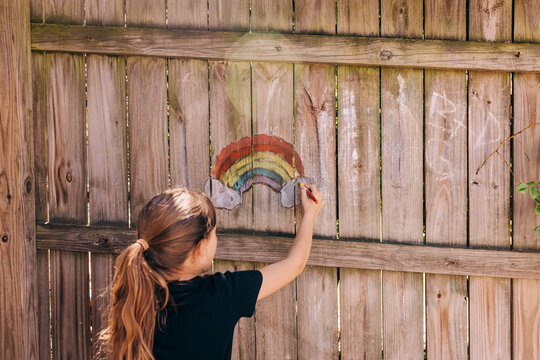 Rainbow chalk drawing on fence