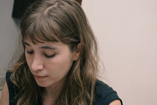Portrait of a young blonde woman looking down