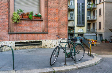 Fototapeta na wymiar Isolated bicycle in via Melegari, a street of Porta Venezia district, Milano city center, Italy