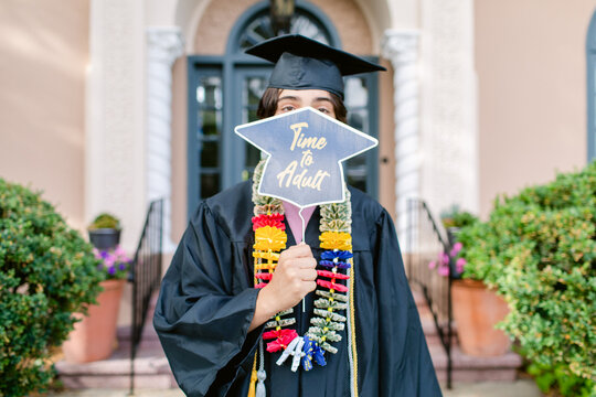 Teen with banner on his graduation day