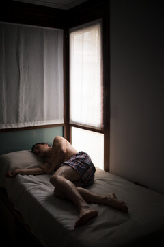 Teenager suffering from depression on bed