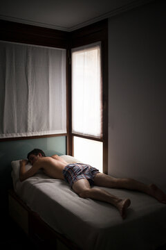 Asleep teenager lying on bed in underwear