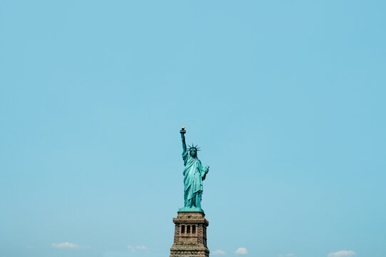 the Statue of Liberty against the sky - Powered by Adobe