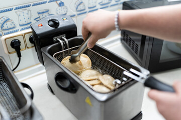 Person frying Venezuelan empanadas.