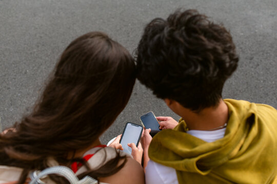 Teenagers paying each other with phone