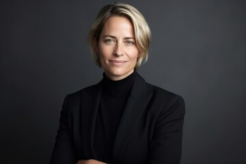 Fototapeta premium Portrait of a businesswoman with blond hair on a gray background
