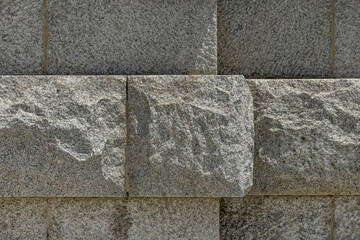 A wall of unpolished granite stones