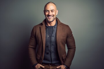 Fototapeta premium Portrait of a handsome mature man in a brown jacket. Studio shot.