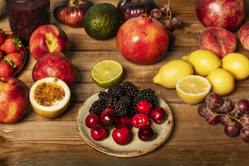 A still life with ripe cherries, seedless grapes, lemons
