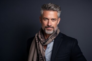 Medium shot portrait photography of a pleased man in his 40s wearing a foulard against a minimalist or empty room background