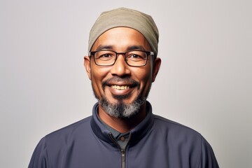 Portrait of a smiling Indian man wearing a head scarf and glasses