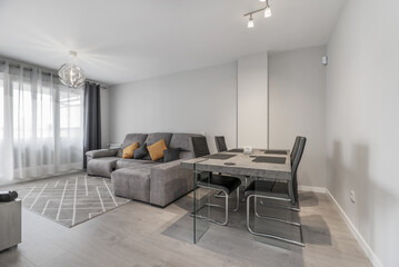 Living room of a house with gray wooden dining table with matching chairs