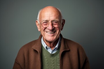 Portrait of a smiling senior man. Isolated on grey background.