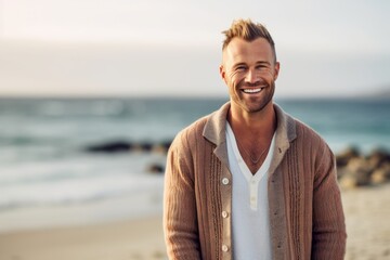 Portrait of handsome man smiling on the beach at the day time