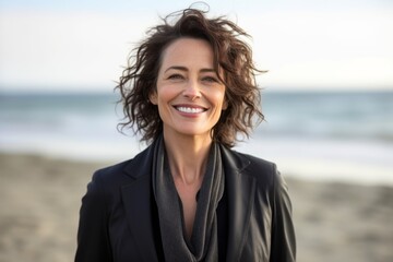 Portrait of a happy mature woman smiling at camera on the beach
