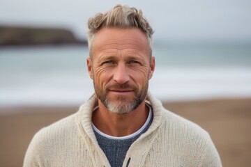 Portrait of handsome man looking at camera at beach on a sunny day