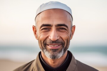 Portrait of smiling middle-aged muslim man at the beach
