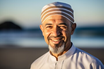 Portrait of smiling middle-aged man on the beach at sunset