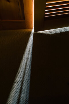 Shaft of Light shining through crack in door in home background