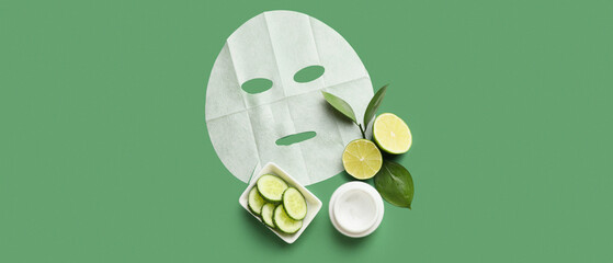 Fabric facial mask with cream, lime and cucumber on green background